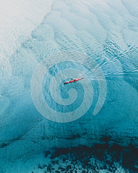 Beach holiday top view with a kayak cruising.