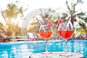 Beach holidays background with two cocktails near swimming pool in luxurious hotel