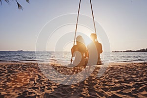 Beach holidays for romantic young couple, honeymoon vacations, silhouettes of man and woman photo