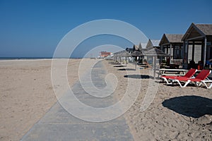 Beach holidays on sandy beach, waterfront relaxation with sun umbrella in Katwijk-on-zee, North sea, Netherlands