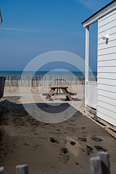 Beach holidays on sandy beach, waterfront wooden cottages in Katwijk-on-zee, North sea, Netherlands