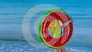 Beach vacations in summer on the seashore. A child with an inflatable ring. Safe rest on the sea. summer tourist offer.