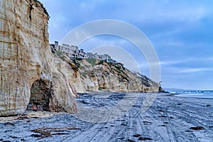 Beach homes on mountain along shore with tire tracks in San Diego California