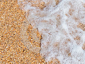 Beach background: sea wave and shell rock
