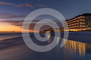 beach hotel lit up during twilight hour