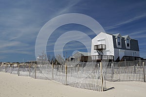 Beach house with hurricane shutters erosion fence