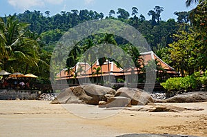 beach with house and rocks