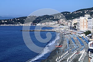 The beach and the houses of the Varazze promenade with the homonymous gulf in the background