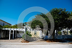 Beach houses with white picket fence and pergola along scenic 30A country road in Santa Rosa, South Walton Beaches near Destin and