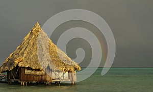 Beach hut & rainbow post storm photo