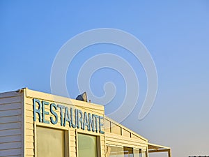 Beach hut with a Restaurant Sign