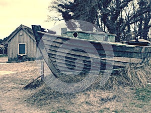 Beach hut at sand dunes, end of road next sea. Old wooden house for fishers.