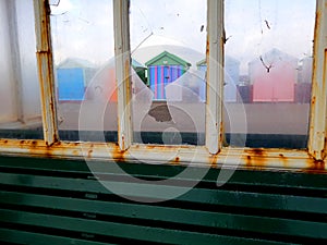 Beach hut seen through smashed window