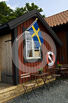 Beach Hut with Swedish Flag and Lifebuoy in Sweden