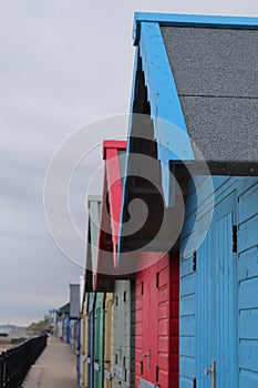 Beach huts in a long colourful row