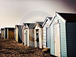 Beach huts on the sand on a cold winter day