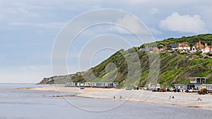 Beach huts sandwiched between the sea and cliffs at Cromer