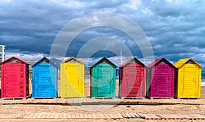 Beach huts Spain bright colours red green blue yellow purple