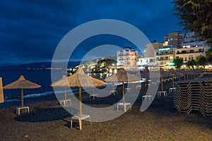 Beach and illuminated buildings at night