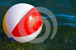 Beach inflatable ball floating in the water