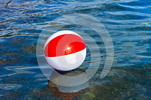 Beach inflatable ball floating in the water