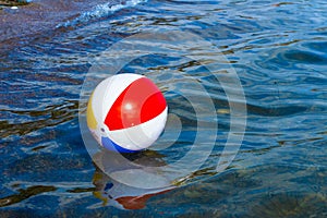 Beach inflatable ball floating in the water