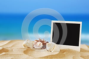 Beach with instant photo in front of sea background