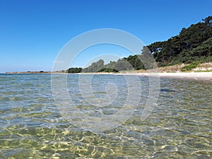 Beach on the island Bornholm in Denmark. Crystal clear water. Vacation holiday travel