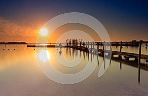 Beach jetty and outdoor swimming pool in Zeewolde during sunrise