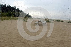 Beach in Jurmala resort seacoast in low season defocused view from the window with rain drops