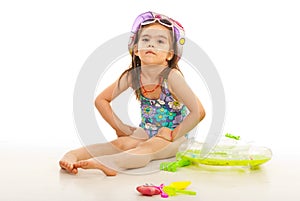 Beach kid girl with toys