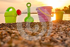 Beach kid`s toys on pebble. Tourism background. Travel with children. Summer vacation concept. Toys on beach. Kids toys