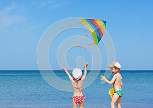 Beach kite children siblings play fun