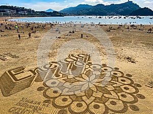 Beach of La Concha in San Sebastian, Spain. Sand graffiti