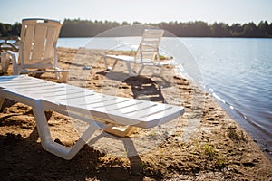 Beach on the lake. empty deck chairs. nobody