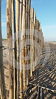 Beach landscape with a wood fence shadows