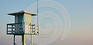 Beach lifeguard observation tower at sunset photo