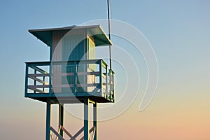 Beach lifeguard observation tower at sunset photo
