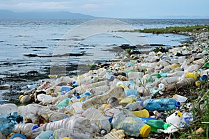 A beach littered with plastic trash, polluting the ocean and harming marine life