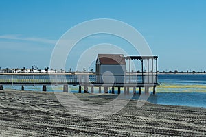 The beach at Lo Pagan on the Mar Menor in Spain.  A wooden jetty at the seaside.