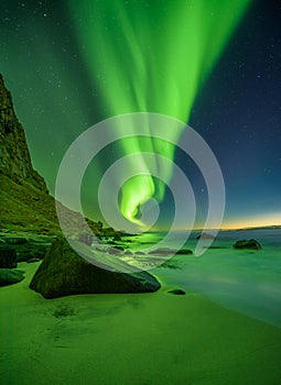 Beach in the Lofoten islands in Norway with northern lights