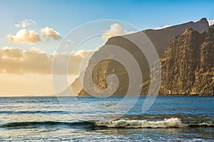 Beach in Los Gigantes with high cliffs on the sunset. Tenerife, Canary Islands.