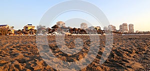 Beach lounge chair and beach umbrella at lonely sandy beach