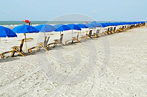 Beach lounge chairs with umbrellas