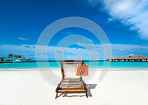 Beach lounger on sand beach.