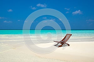 Beach lounger on sand beach