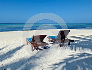 Beach loungers on the dream white beach of the Maldives