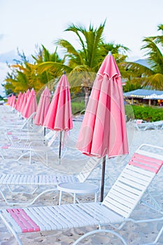 Beach lounges under an umbrella on white sand