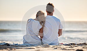 Beach, love and couple relaxing on the sand while watching the ocean waves together on vacation. Travel, romantic and