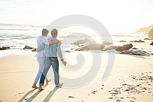 Beach, love and mockup with a senior couple walking on the sand by the ocean or sea for sunset romance. Nature, summer